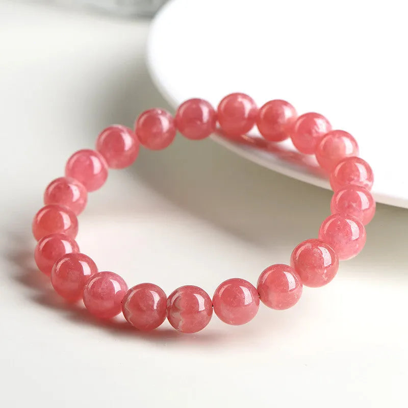 Women's natural red rhodochrosite crystal bracelet with geometric design and longevity lock fastening