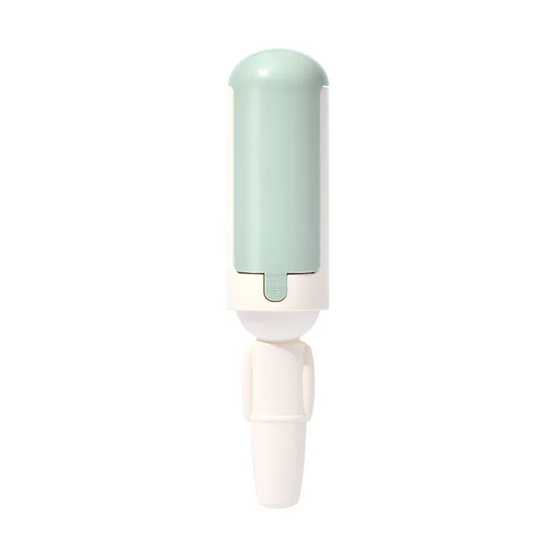 White green coloured pet hair remover roller with a non-slip handle on a fabric sofa.