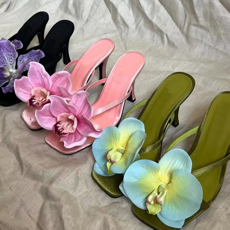 Pink women's high heel sandals with artificial white phalaenopsis flowers on the satin upper