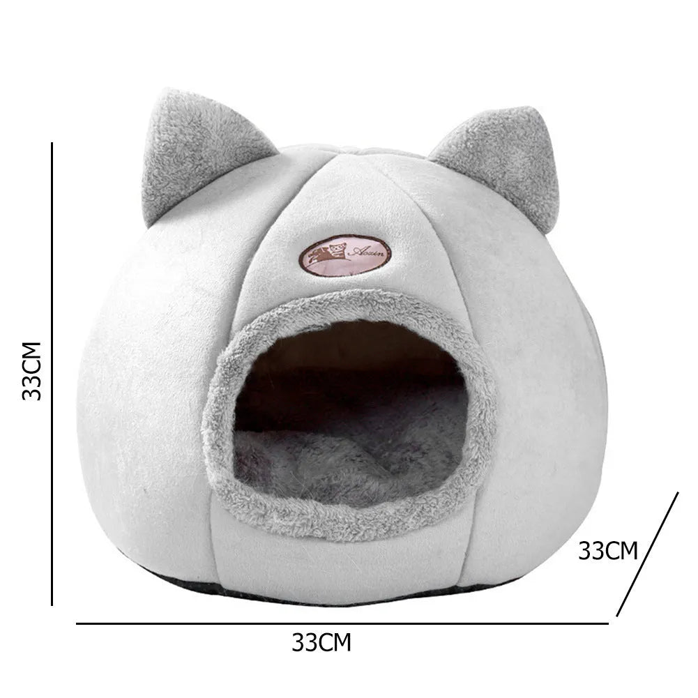 Large fully enclosed fabric cat house with a single entrance, shown in a home setting.