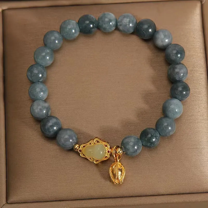 Sky blue natural stone bracelet with carved lotus and gourd pendant on electroplated brass setting