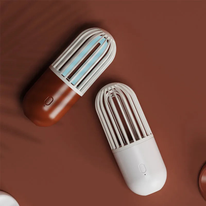 Compact portable UVC disinfection lamp in capsule design showing black, brown, green, and white colour options.