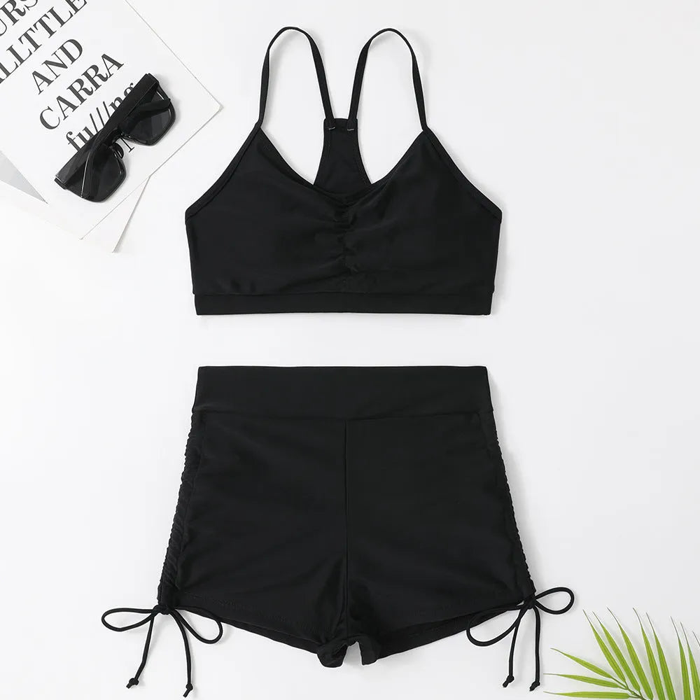 Women's high-waisted split swimsuit in purple or black, showing sleeveless design and split style for swimming.