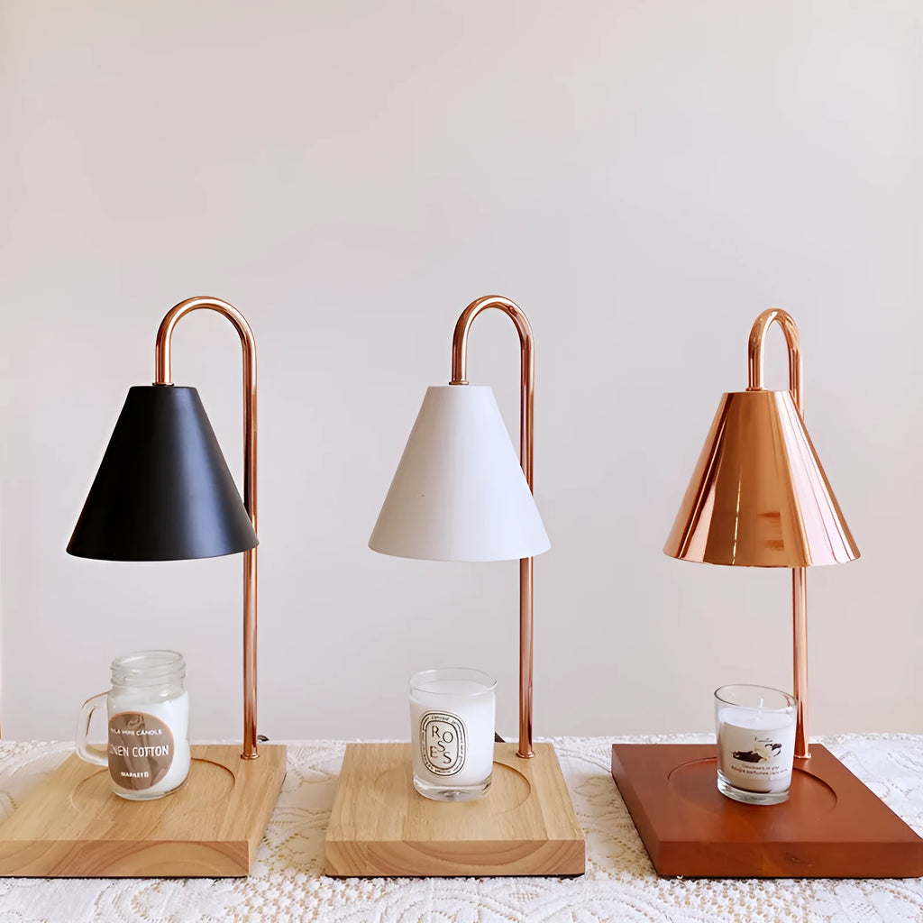 White and log coloured electric candle warmer lamp with dimmer switch on desk