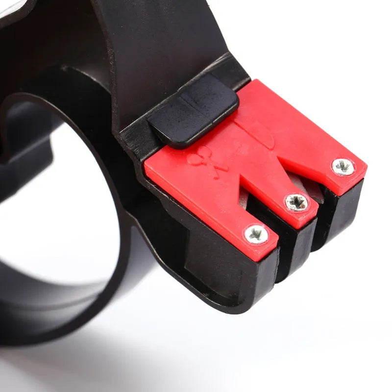 Black handheld tungsten steel knife and scissor sharpener on a kitchen counter