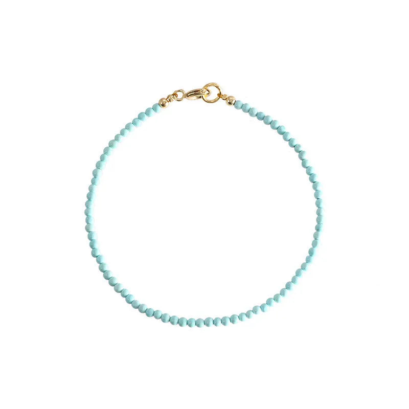 Natural 2mm raw ore turquoise bracelet on wrist, showing geometric beads and adjustable extension chain.
