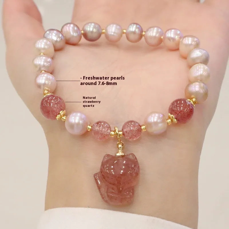 Light pink freshwater pearl bracelet with a strawberry quartz fox charm on a metal chain.