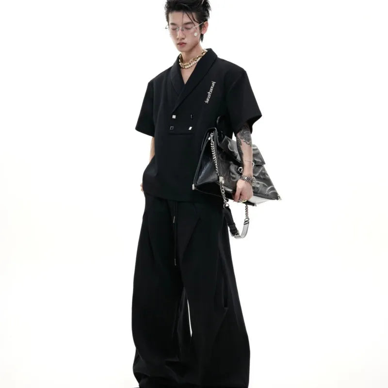 Men's dark grey V-neck sports suit with padded shoulders and metal embellishments on cotton fabric