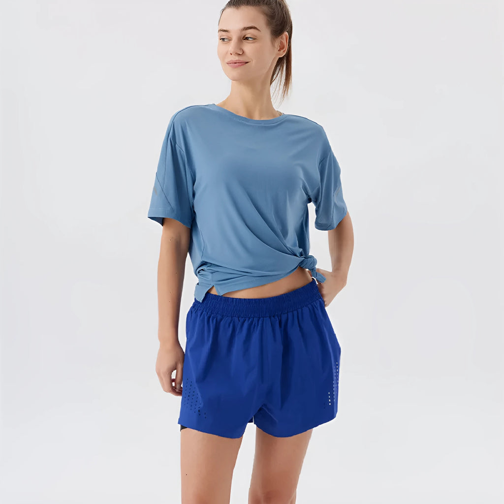Men's straight-cut nylon sports shorts with side slits, shown in turmeric yellow, for summer athletic wear.