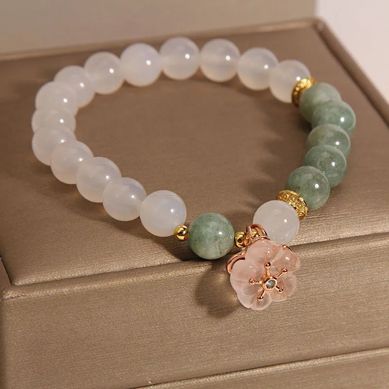 White agate jade bracelet with pink floral detailing and adjustable fastening