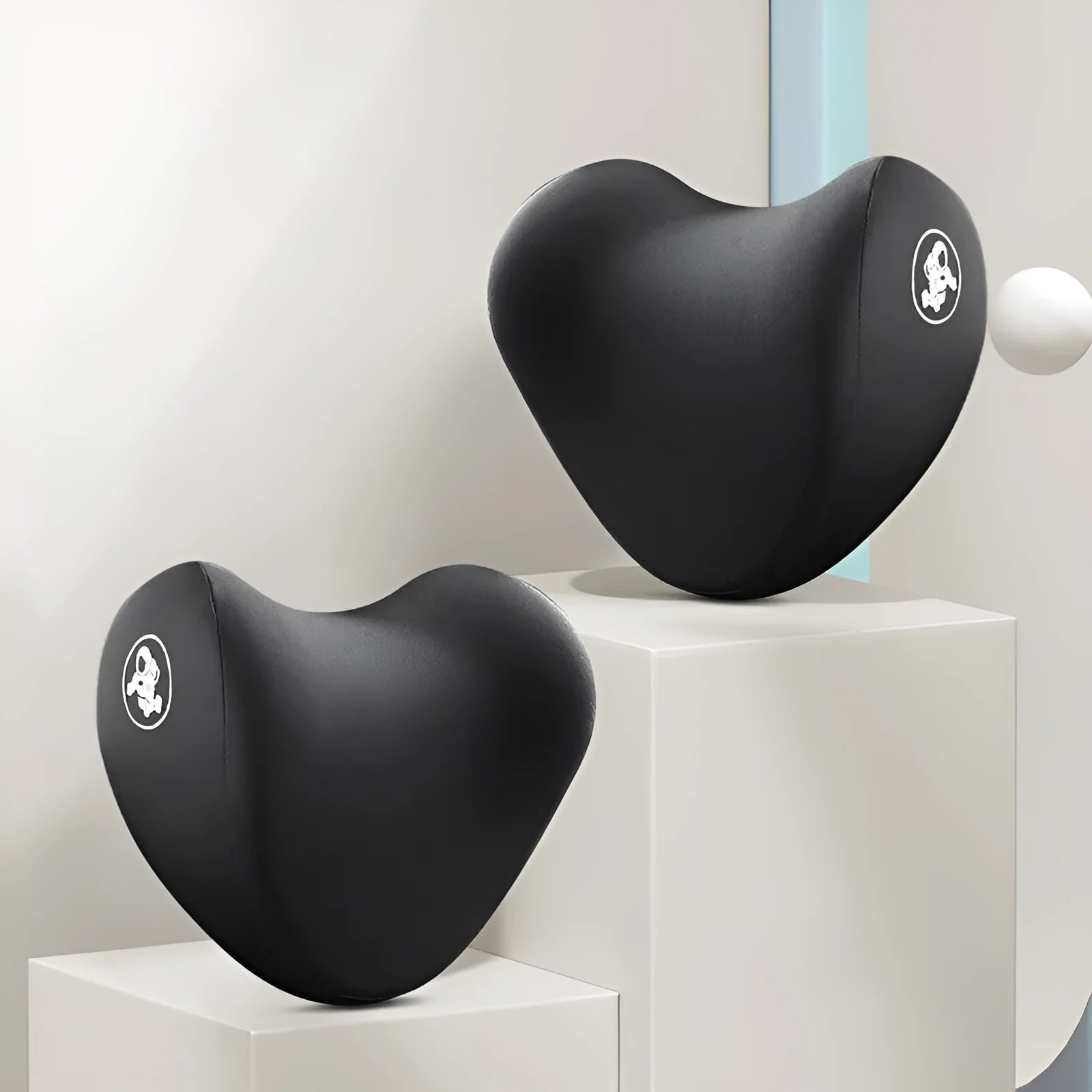 Heart-shaped black and grey car pillow set for headrest and lumbar support on a car seat.