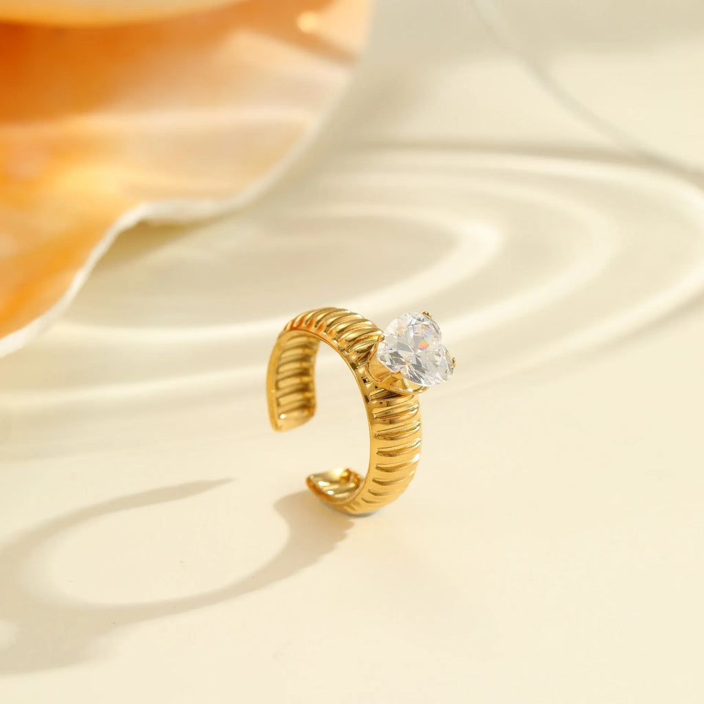 Gold coloured stainless steel ring with geometric and heart shapes, open mouth adjustable design.