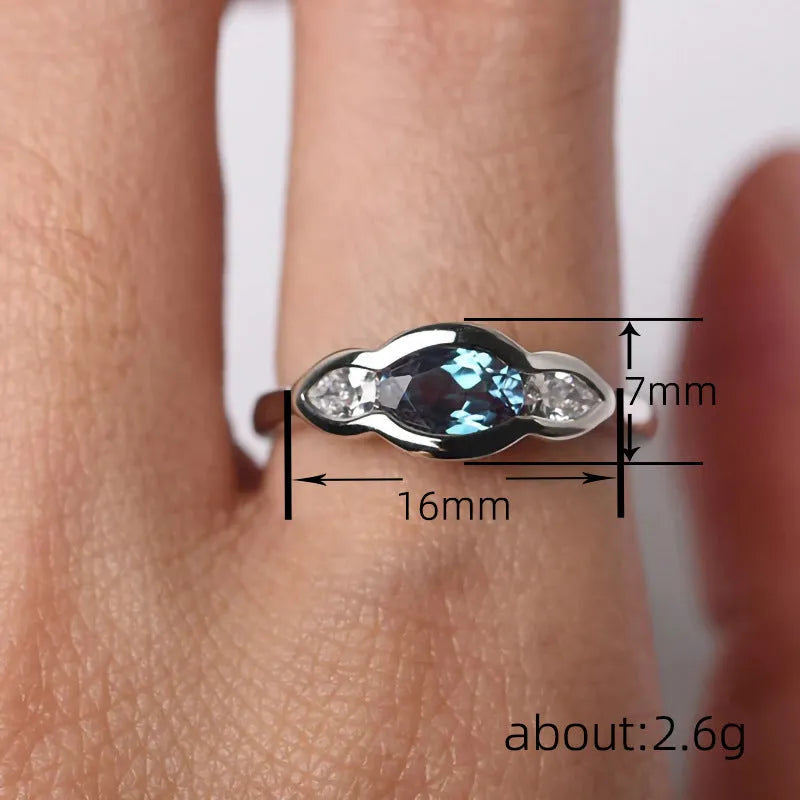 Geometric ellipse copper ring with zircon inlay, white gold colour finish, shown in size options 6-10