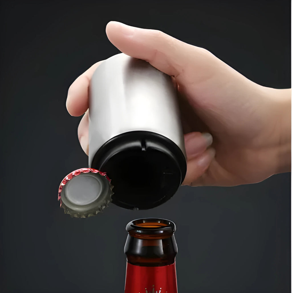Stainless steel automatic beer bottle opener in assorted colours on a wooden surface.