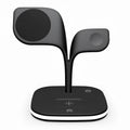 Black or white desktop wireless charging stand holding a phone, with outputs for headphones and a watch.