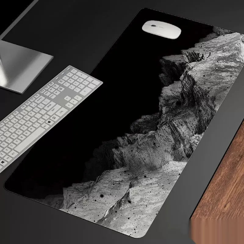 Oversized gaming mouse pad on desk showing 900x400mm dimensions with cold style design and natural rubber base