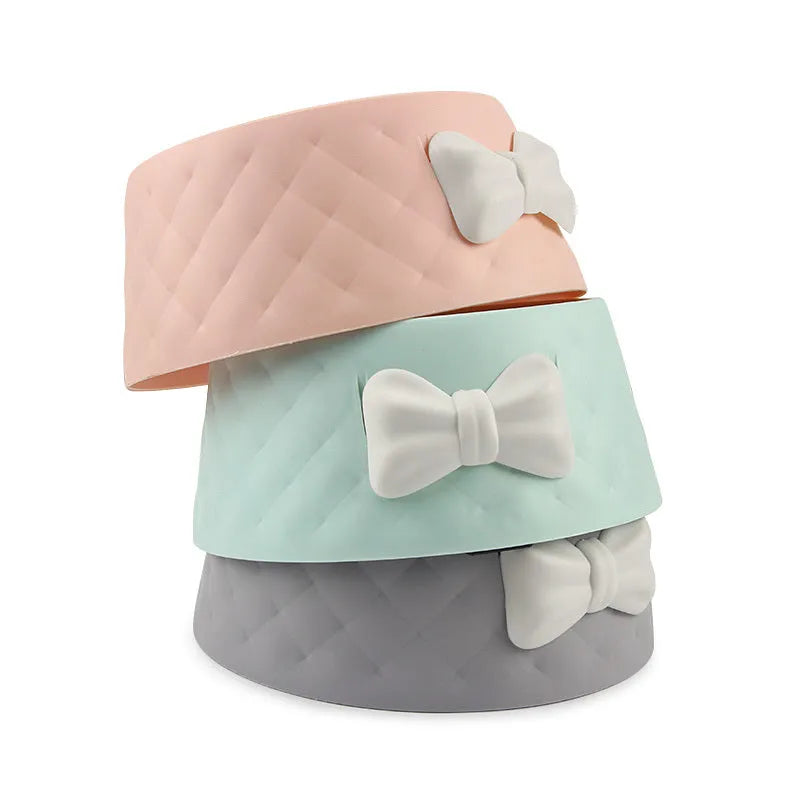 Bow-shaped cat bowl dog bowl in PP plastic, shown in pink, green, and grey.