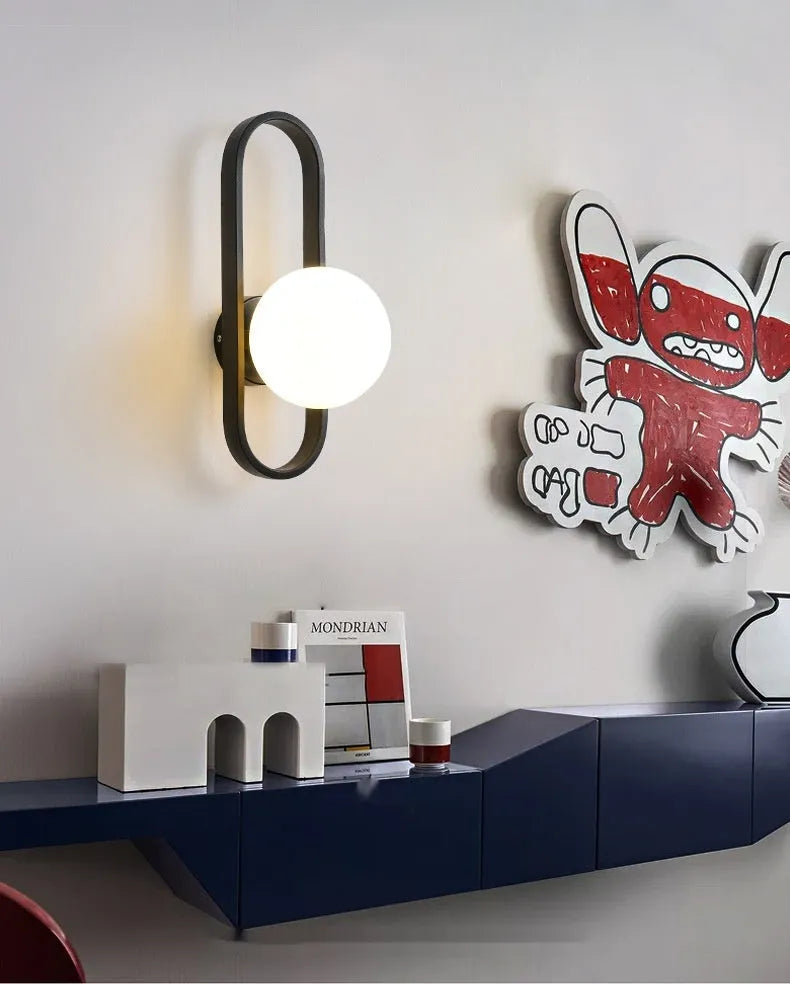 Minimalist wall lamp in black or gold with glass shade and iron body, showing 12W LED tri-colour lighting