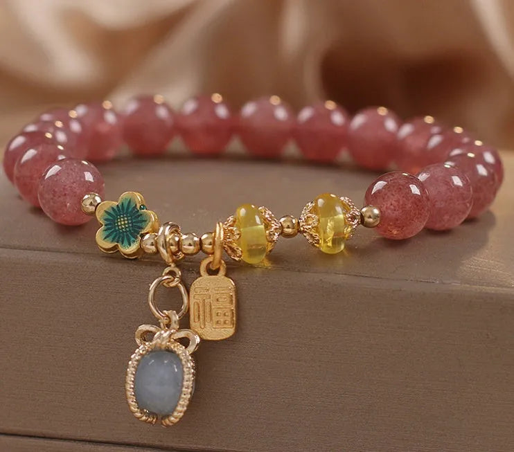 Red strawberry quartz beaded bracelet with alloy setting and rhinestone decoration