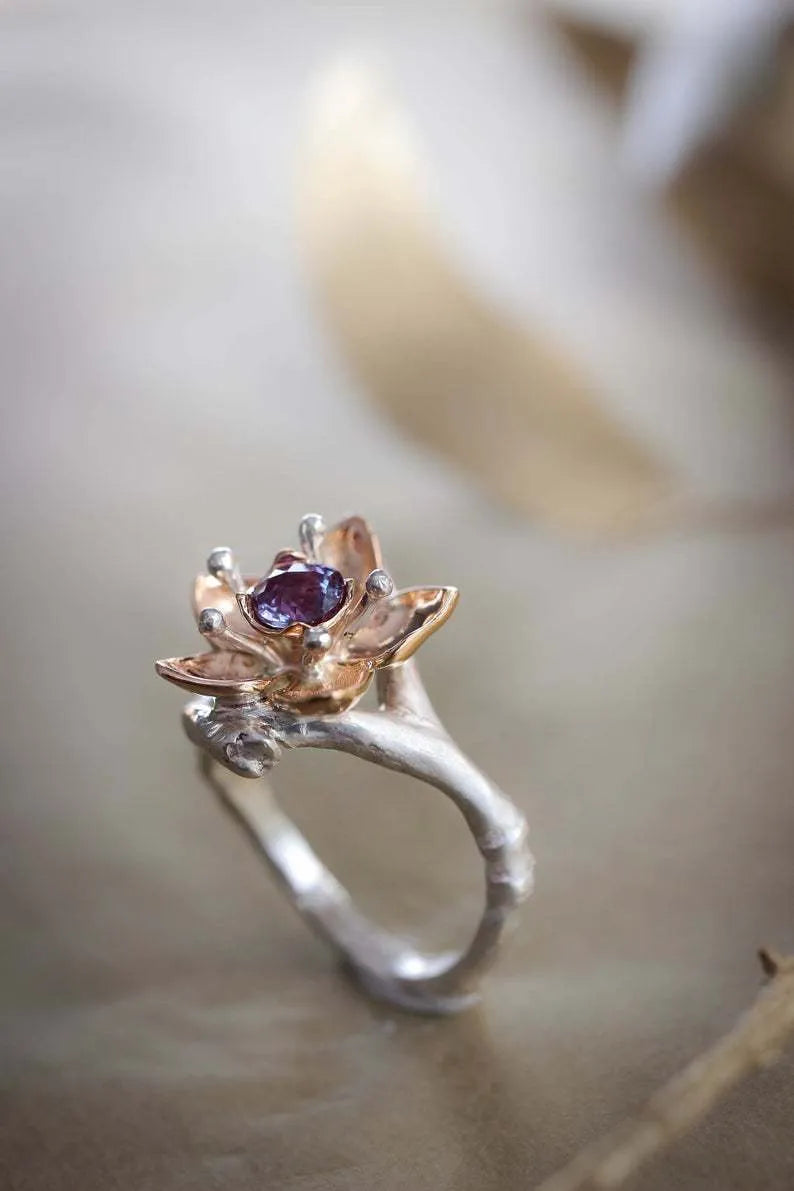 Two-tone floral fashion ring with geometric shape and silver colouration, shown in size for women's accessory.