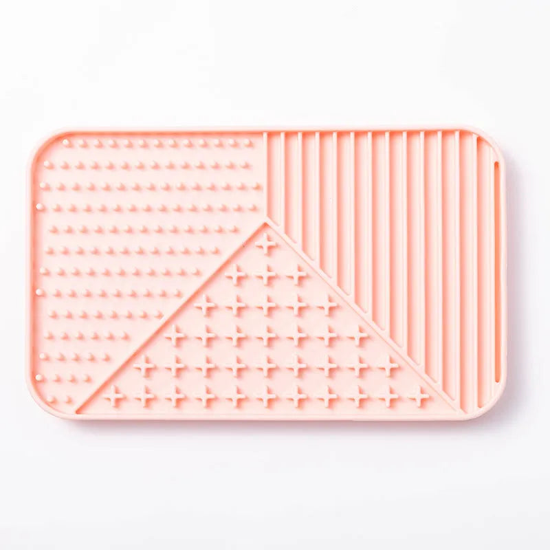 Grey silicone pet licking mat with textured surface and a white suction cup on the back.
