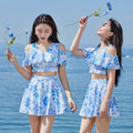Blue floral patterned women's one-piece swim dress on hanger