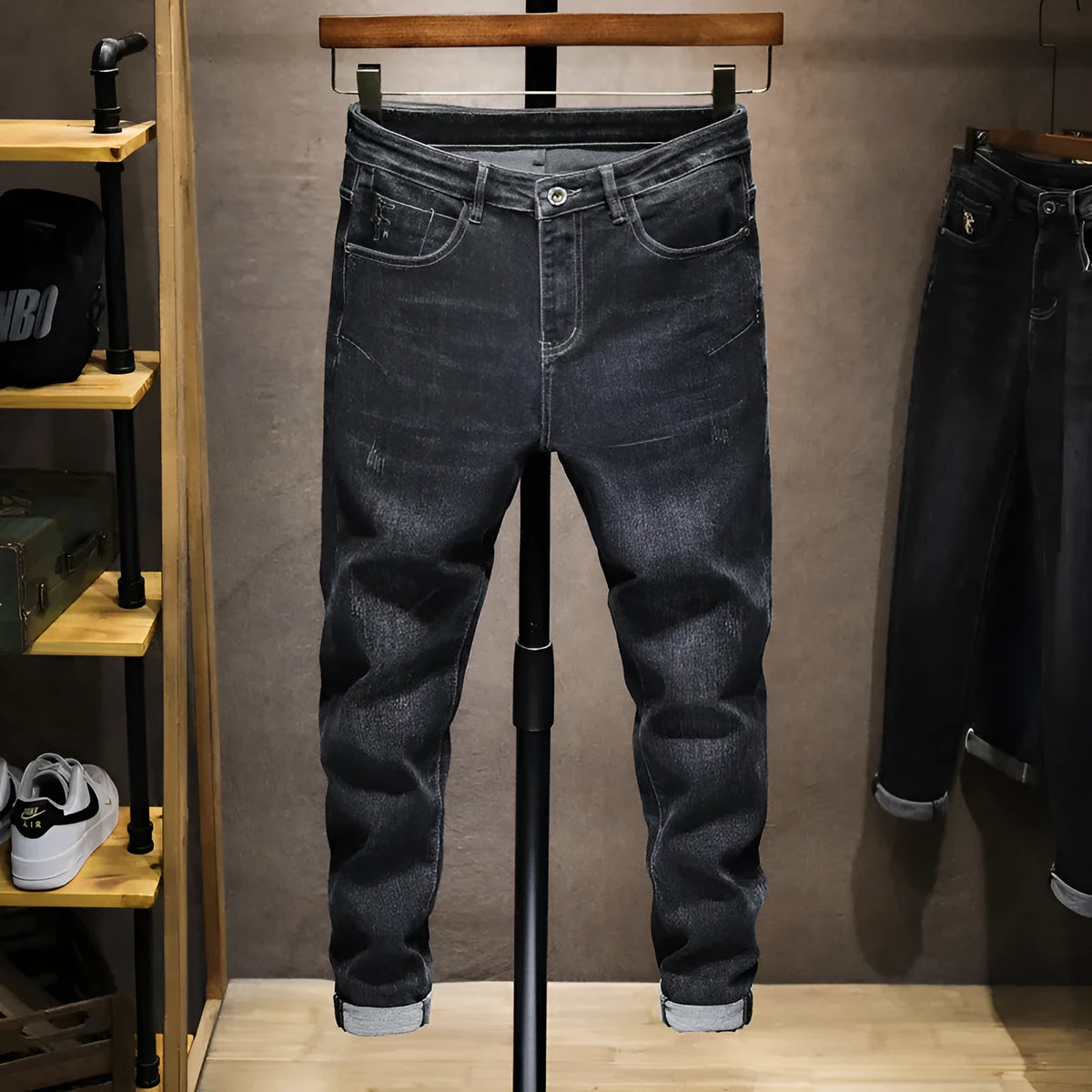 Men's dark grey loose straight-leg cotton denim jeans with mid waist, zip fly and cat whisker finish