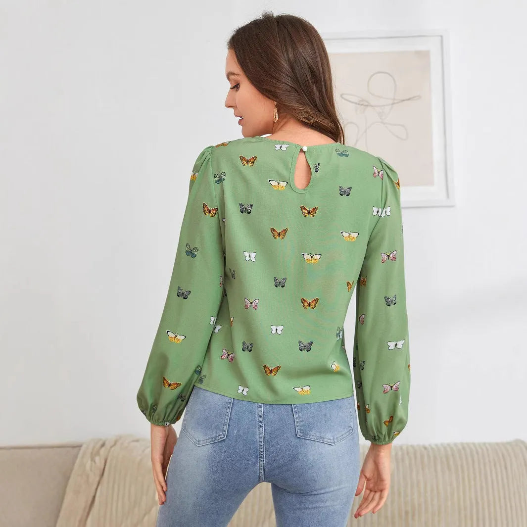 Women's butterfly print long-sleeved shirt in green colour showing loose fit and regular sleeves