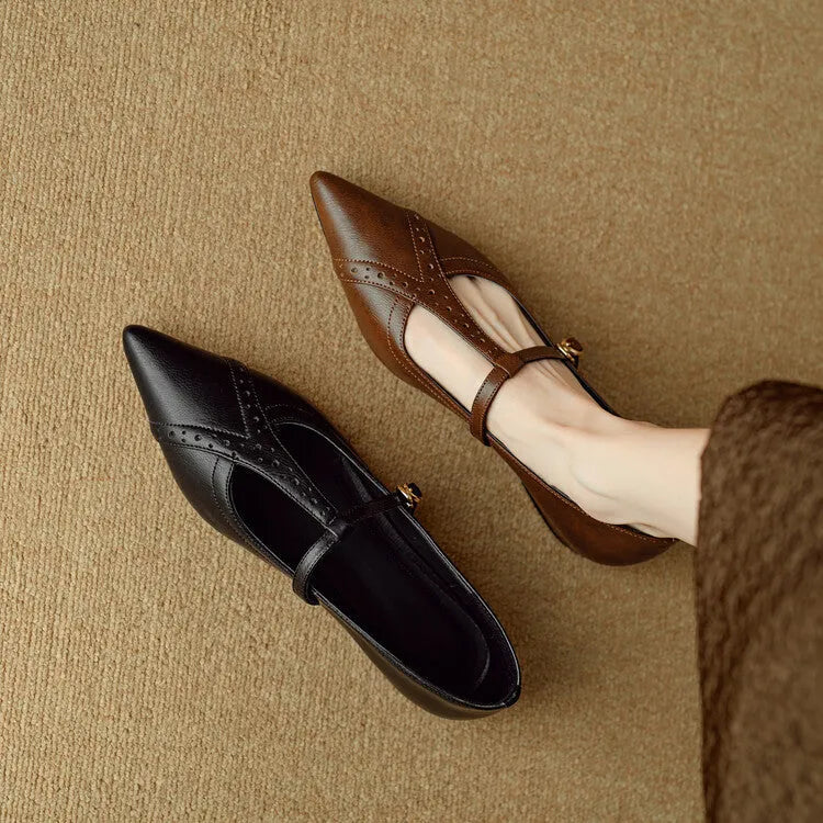 Brown women's rounded toe cowhide flat shoes with a low heel on a neutral background.