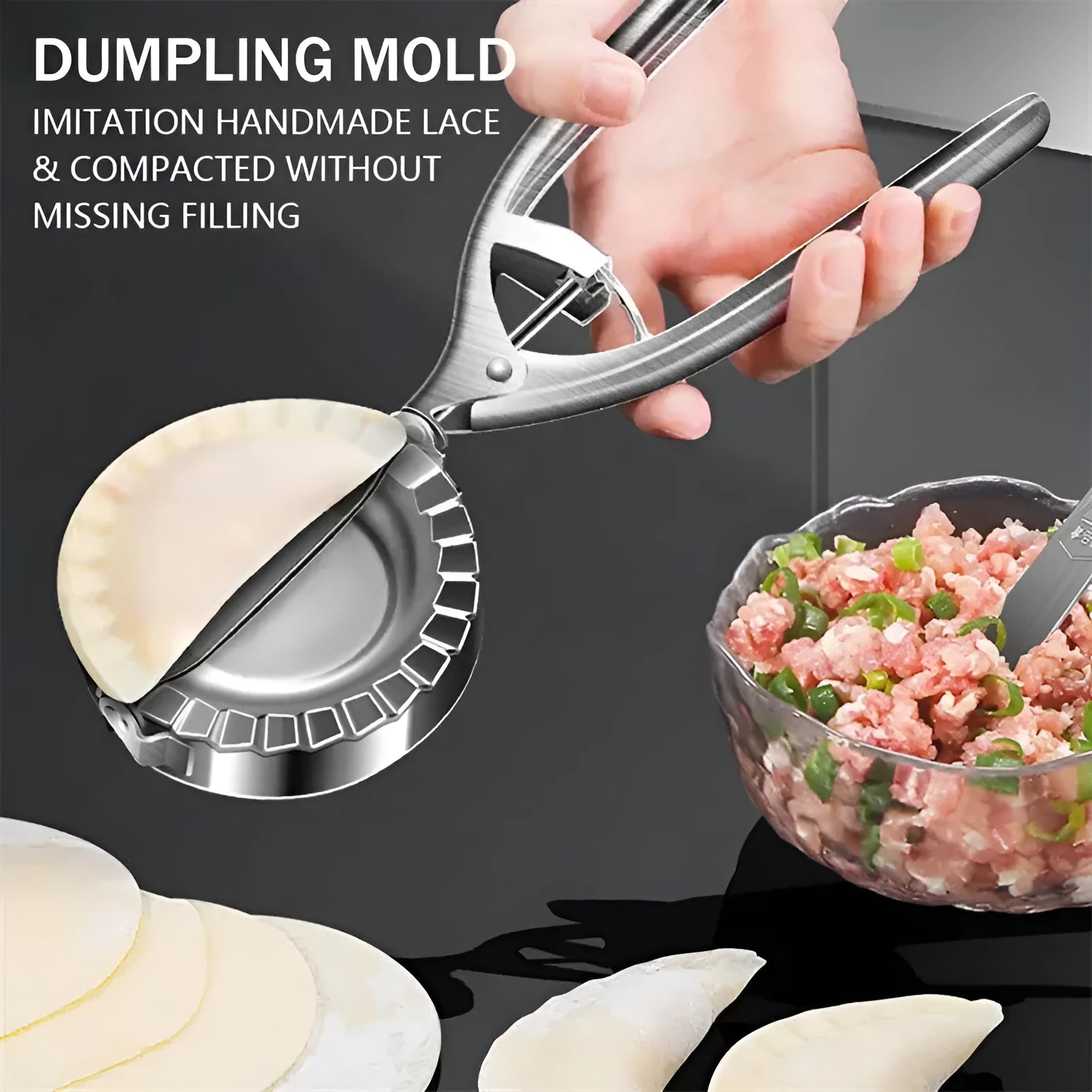 Silver stainless steel manual dumpling press mould with handle on a kitchen worktop.