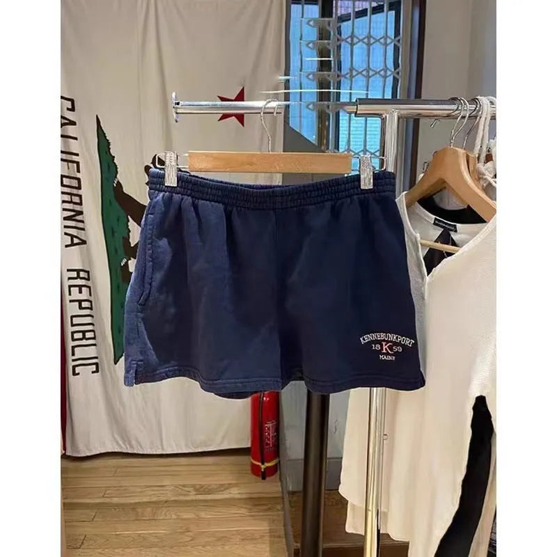 Women's dark blue cotton sports shorts with white flag embroidery and free size fit for athletic activities
