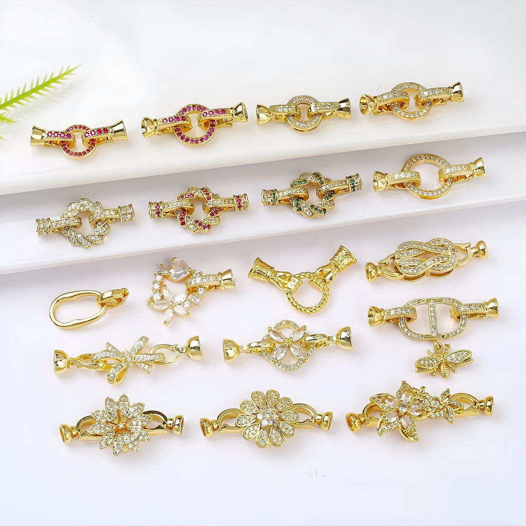 Small gold colour necklace clasp chain buckle on a white background