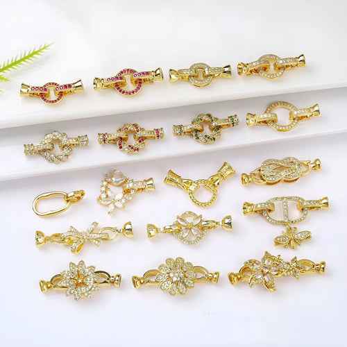 Small gold colour necklace clasp chain buckle on a white background