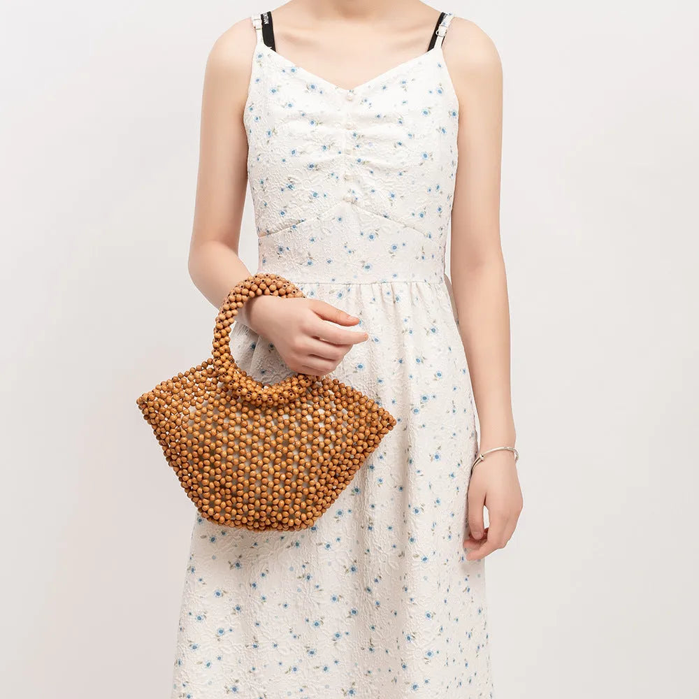Hand-woven maple wood beach bag with wooden beads in dumpling shape.