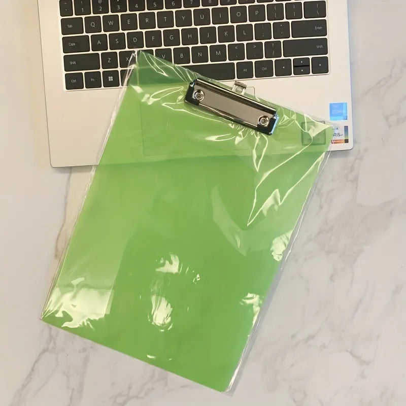 Clear A4 plate holder with metal clip and transparent writing pad in blue colour on a desk.