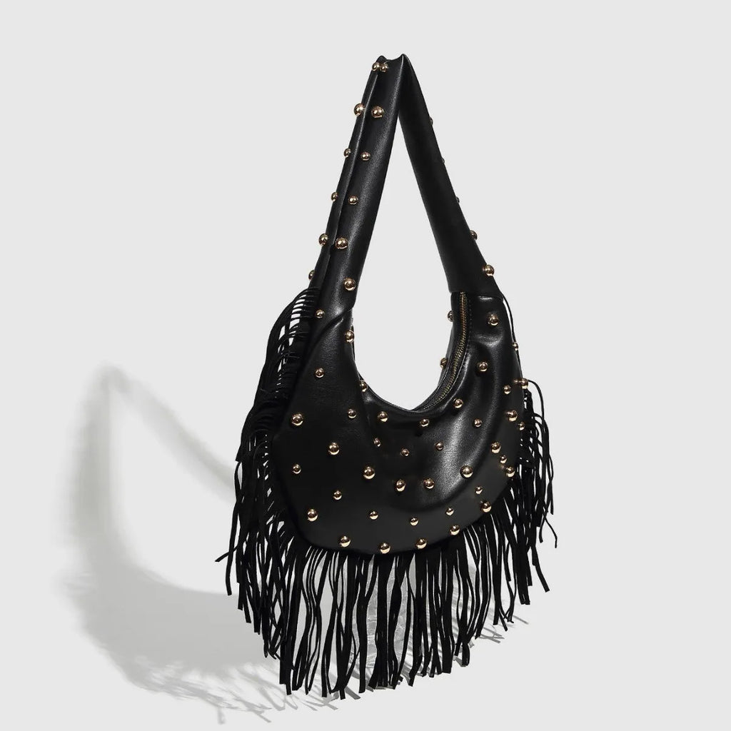 Retro tassel shoulder handbag in wine red with medium hardness construction and internal mobile phone compartment