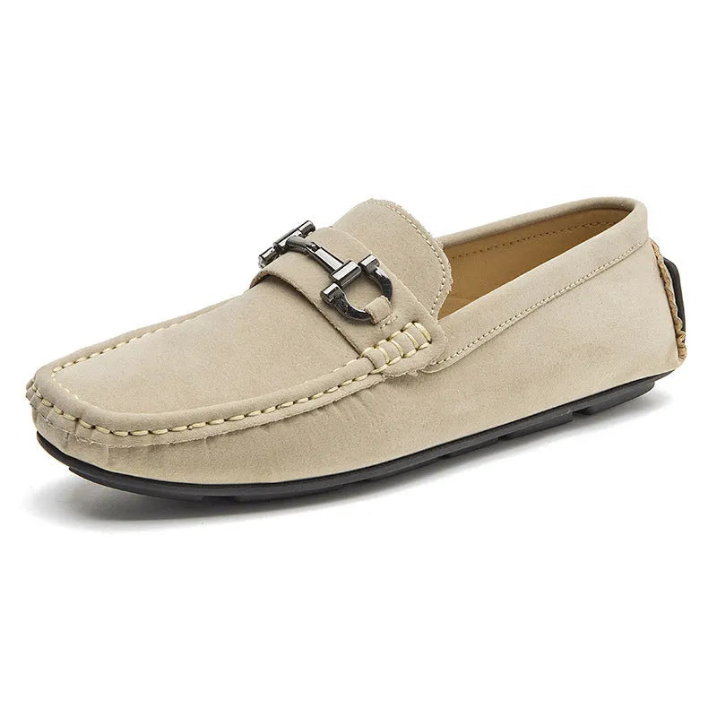 Men's beige slip-on loafers with a round toe and rubber sole on a plain background.