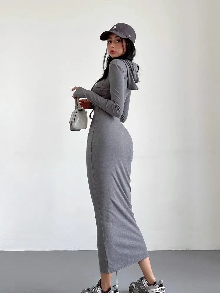 Women's grey hooded sheath dress with over-the-knee length and long sleeves showing high waist design