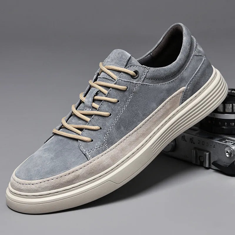 Men's grey casual skate shoes with pigskin upper and rubber sole showing lace-up front and round toe design