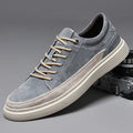 Men's grey casual skate shoes with pigskin upper and rubber sole showing lace-up front and round toe design