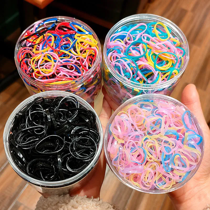 Multicoloured TPU baby hair ties in a reusable plastic container, pack of 300 or 600.