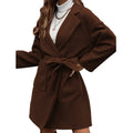 Minimalist long sleeve lapel coat with a split belt in a light blue colour, shown on a model.