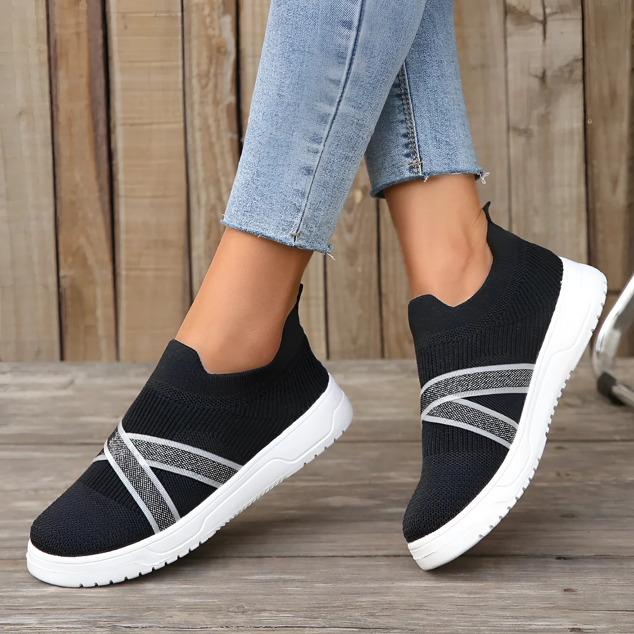 Women's black flyknit mesh casual shoes with flat rubber sole and tassel detail