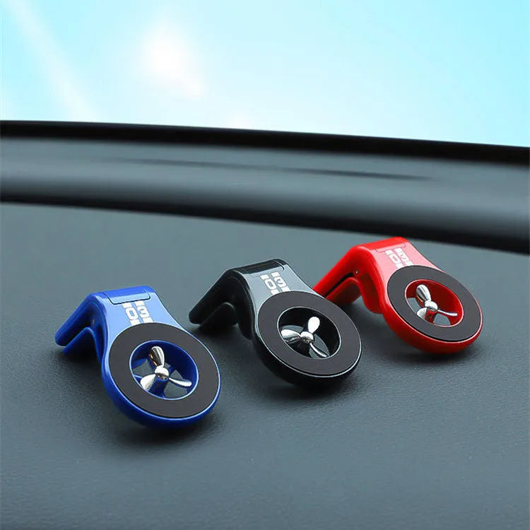 Magnetic car phone holder mounted on air vent with phone attached, showing 360-degree rotation and fragrance slices