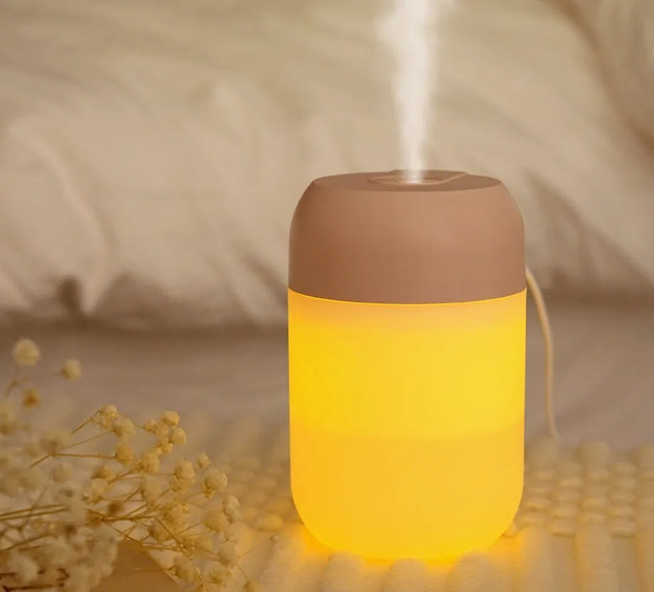White cylindrical USB mini humidifier with charging cable, measuring 15cm height