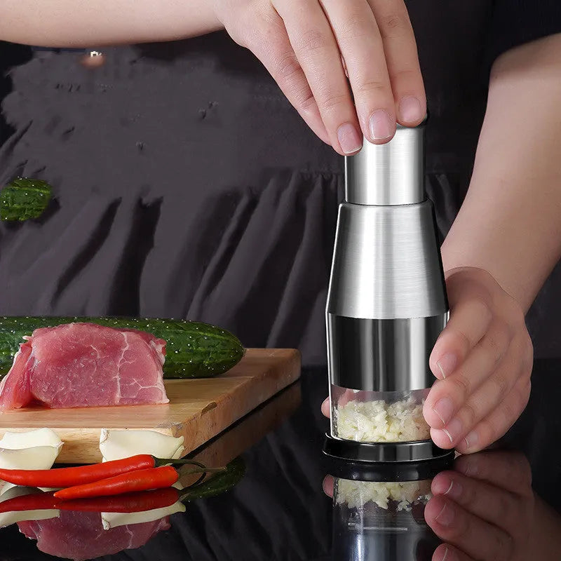 Manual garlic crusher and onion chopper with stainless steel blades on food-grade plastic base