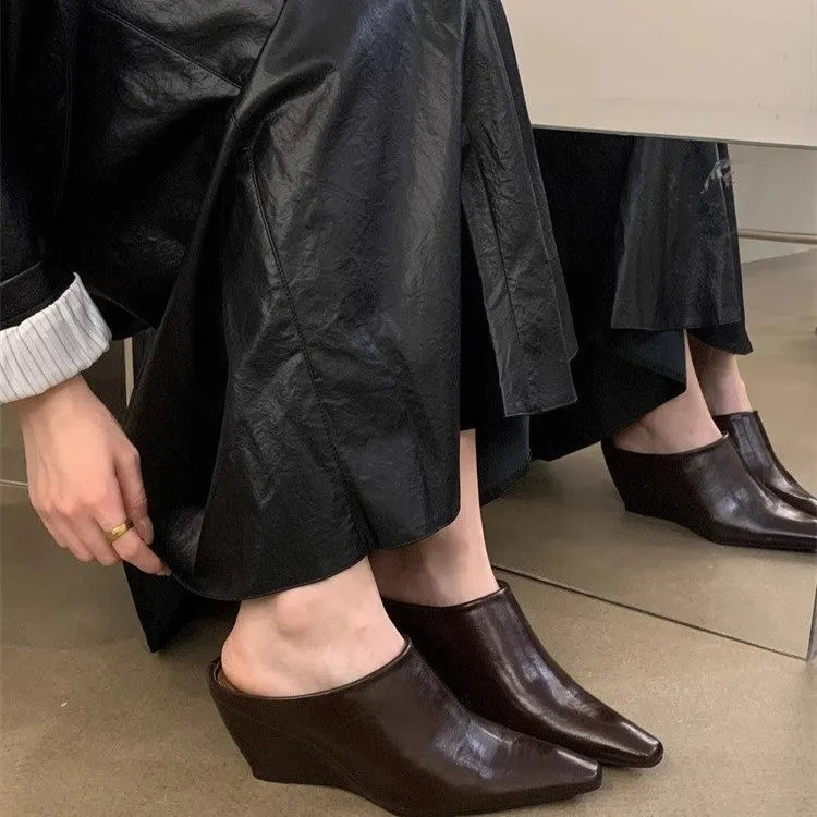 Women's black Wind Wedge closed toe half slippers with PU upper on a plain background.