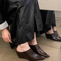 Women's black Wind Wedge closed toe half slippers with PU upper on a plain background.