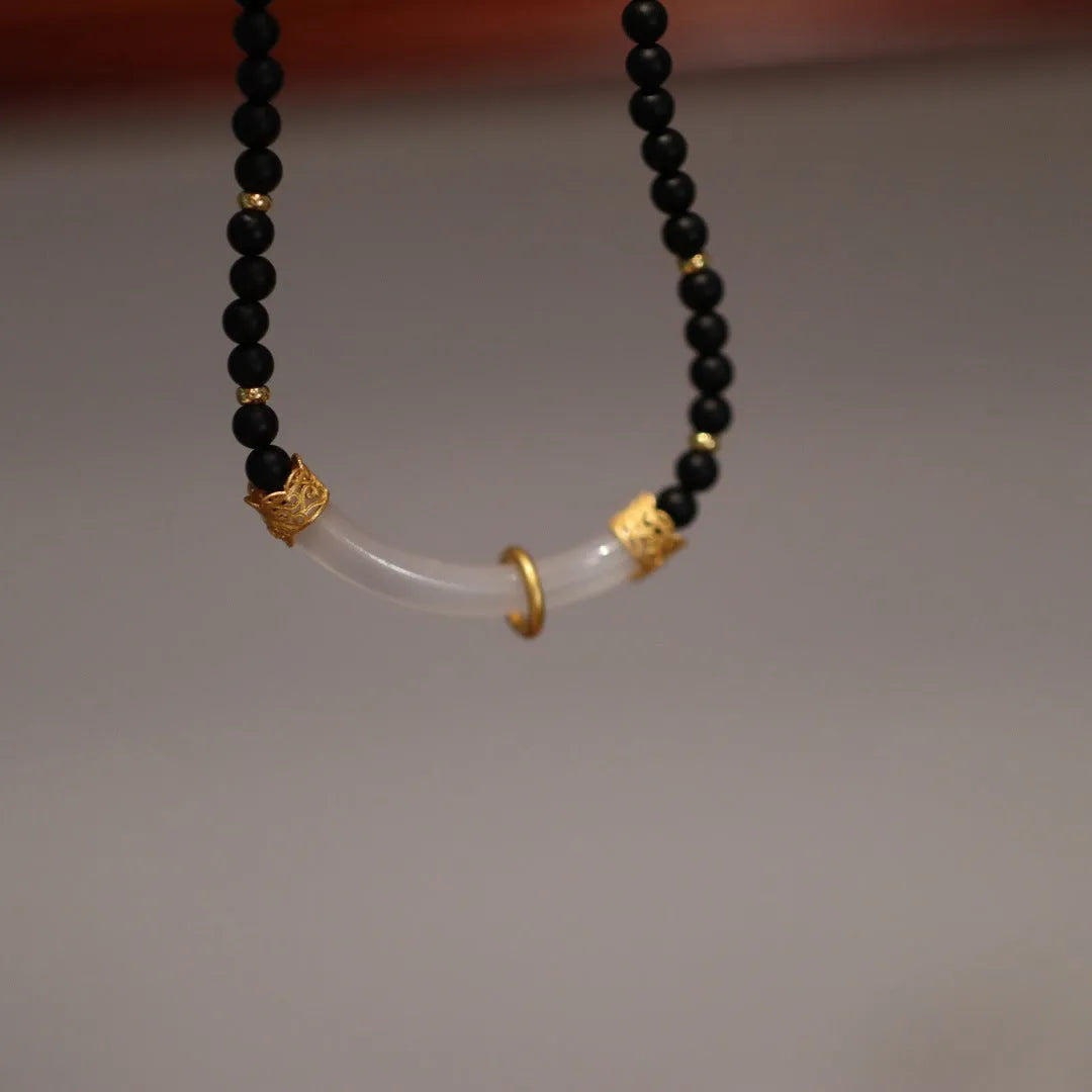 Chinese style U-shaped frosted black agate and white chalcedony necklace on beaded silver chain.