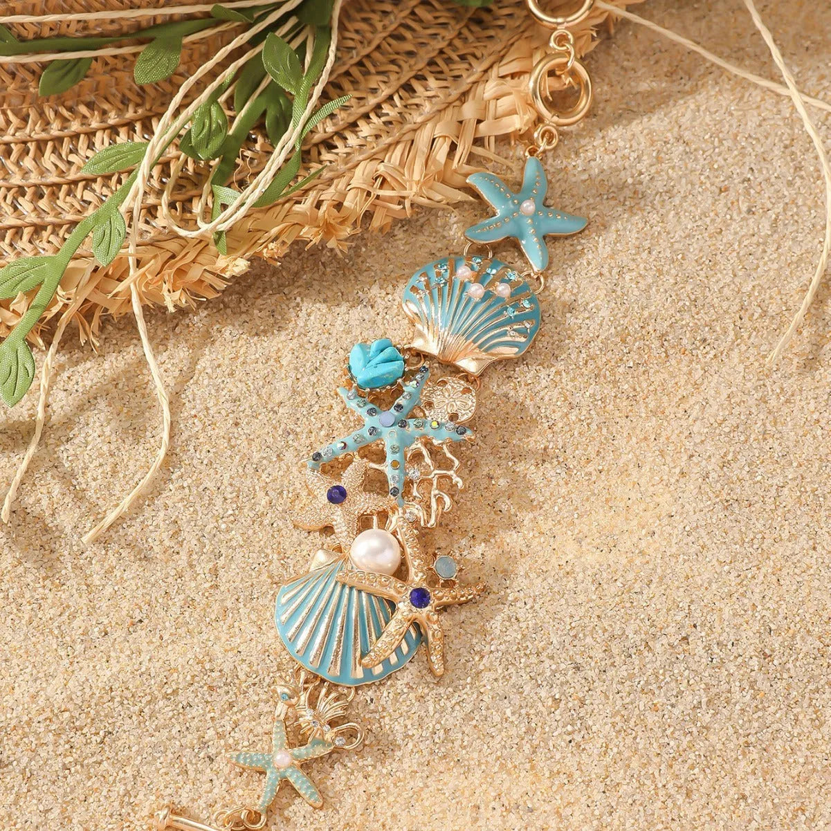 Women's alloy bracelet with starfish design in turquoise, coral red, or coral blue with marine shell and boat anchor elements